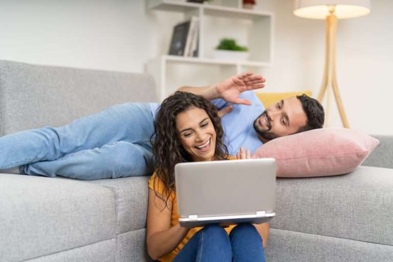 Couple doing a video call online using laptop together